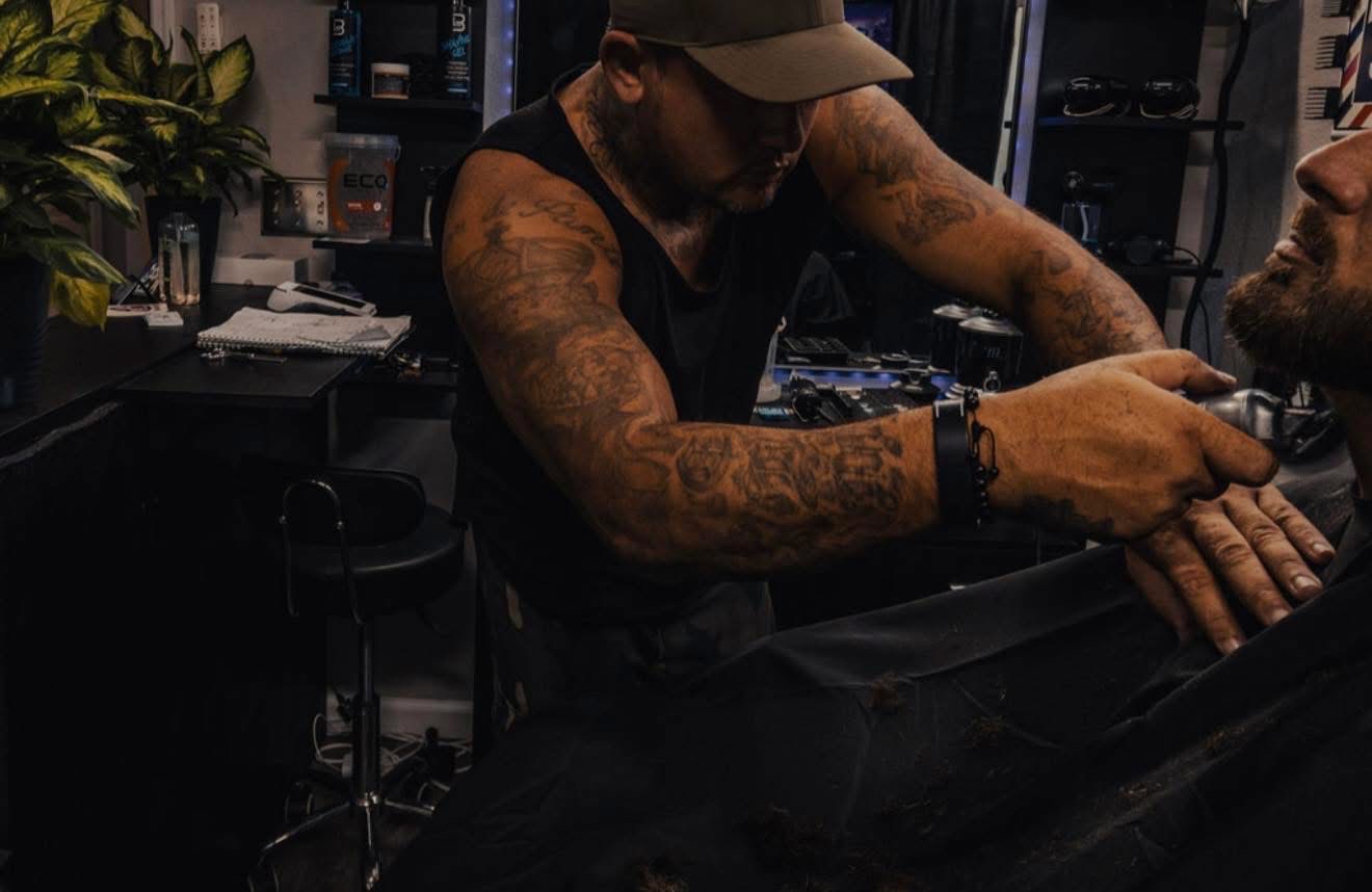 Rich cutting a client's hair